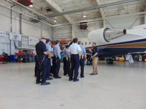 Operations Manager Travis Bryan goes through aircraft fire safety with Boca Raton Fire Rescue personnel