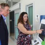 Demonstrating kiosk to clear customs at Customs and Border Protection Service facility tour