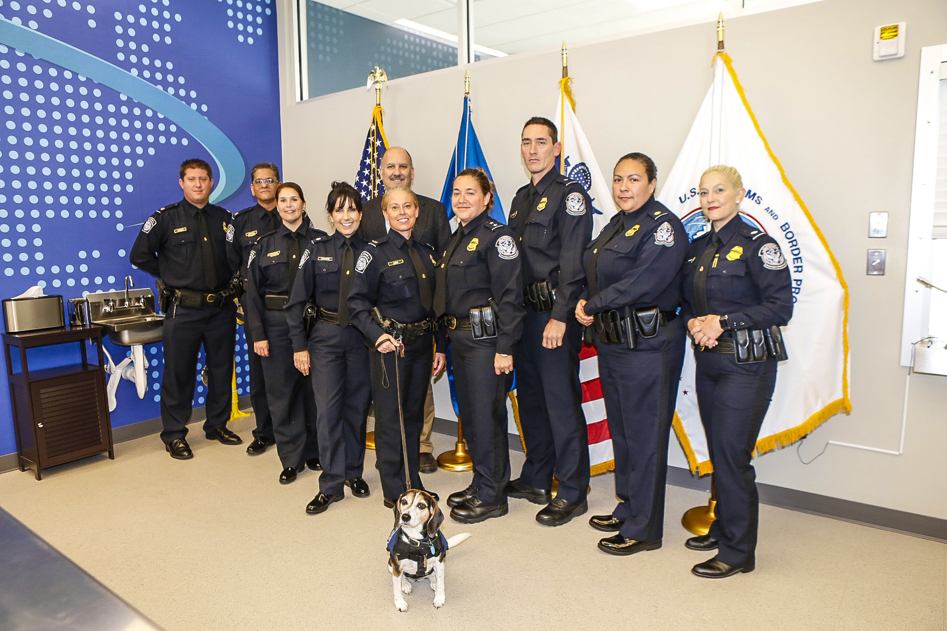 U.S. Customs team, and beagle, at grand opening ceremonies at BRAA U.S Customs & Border Protection Service office