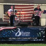 City of Boca Arts and Craft event, Band plays with BRAA banner on stage display