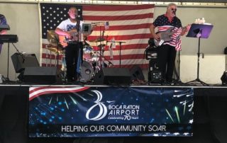 City of Boca Arts and Craft event, Band plays with BRAA banner on stage display