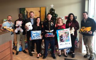 BRAA Staff with U.S. Marine before loading the Toys for Tots donations.