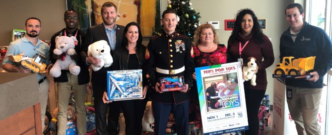 BRAA Staff with U.S. Marine before loading the Toys for Tots donations.