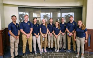 Nine students pose for photo