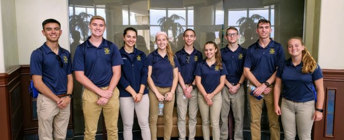 Nine students pose for photo