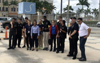 Boynton Aerospace Science Academy students pose for photo outside Signature Flight Support.