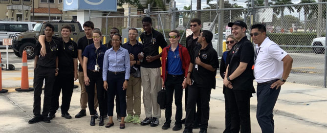 Boynton Aerospace Science Academy students pose for photo outside Signature Flight Support.