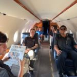Students seated in corporate jet