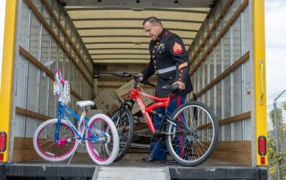 U.S. Marine holding a bicycle