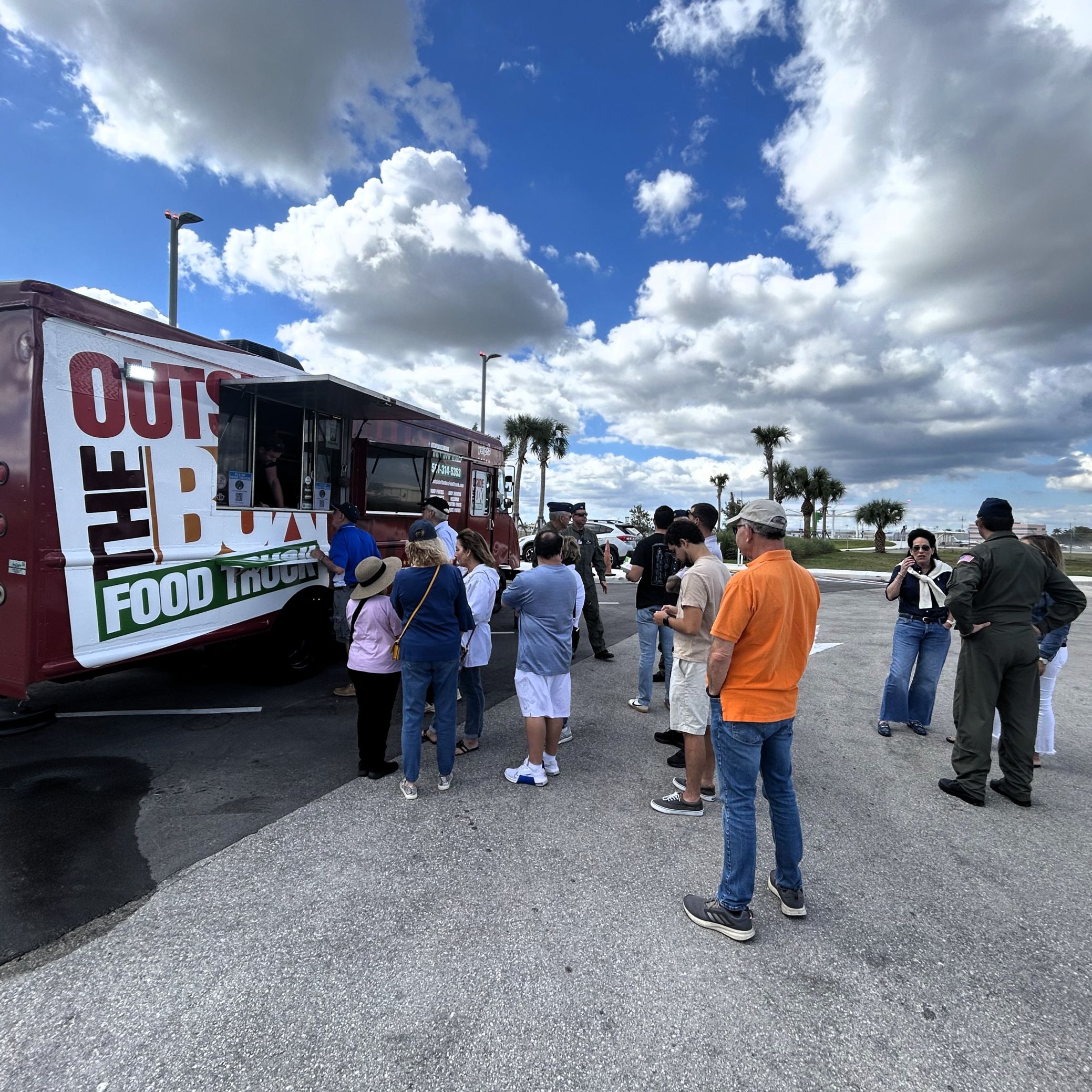 A line of people waiting at a lunch truck